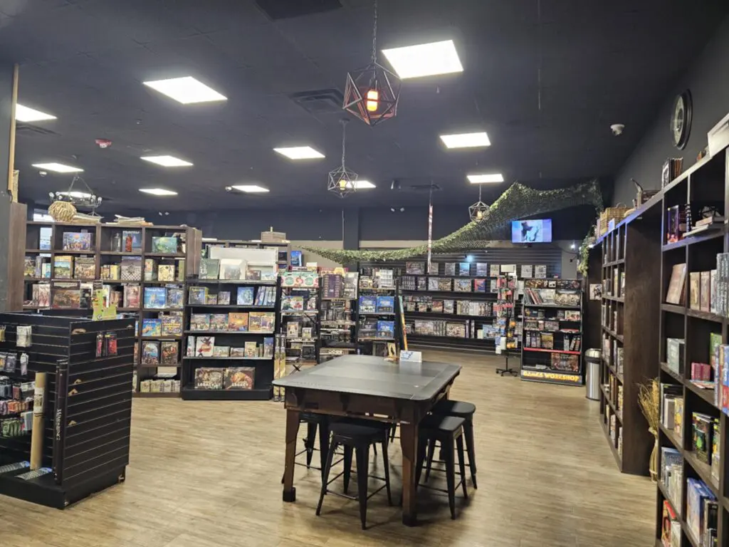 Store interior with games on shelves and gaming table
